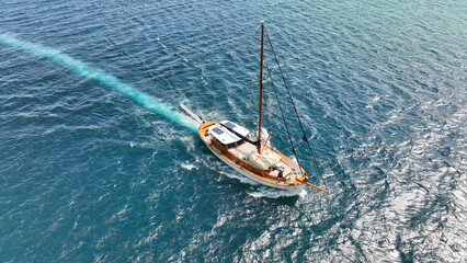 Wall Mural - Aerial drone photo of wooden sail boat cruising deep blue Mediterranean sea