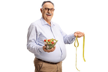 Mature man holding a salad and a measuring tape