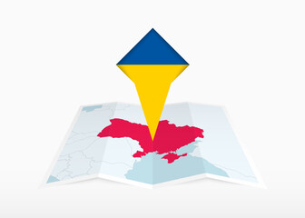 Wall Mural - Ukraine is depicted on a folded paper map and pinned location marker with flag of Ukraine.