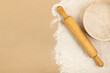 Flour, rolling pin and sieve on the table. Background with flour.