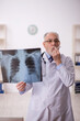 © Elnur - Old male doctor radiologist working in the clinic
