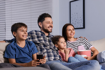 Poster - Happy family watching TV at home in evening