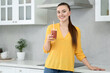 © New Africa - Beautiful young woman with delicious smoothie in kitchen. Space for text