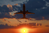 Fototapeta Storczyk - Plane in sky during sunset, low angle view