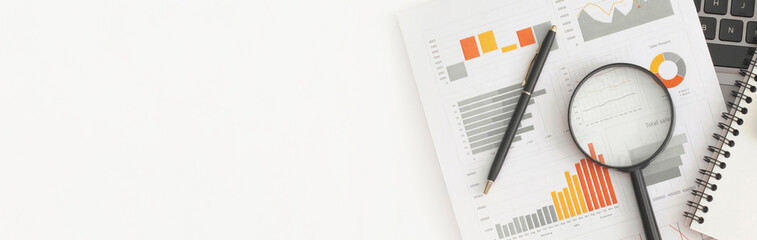 Business graphs, charts, magnifying glass and calculator on table. Financial development, Banking Account, Statistics