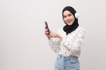 Young beautifu musliml woman wearing headset on white background..