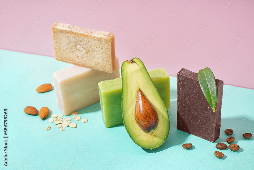 Set of soap bars and natural ingredients on color background