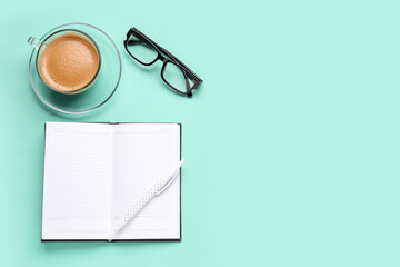 Wall Mural - Composition with blank notebook, coffee cup and glasses on turquoise background