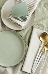 Wall Mural - Ceramic plates mockup on  modern minimal table place setting neutral beige color top view.  Space for text or menu .Scandinavian style tableware. Business food brand template.