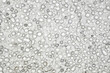 Pumice porous gray structure close-up with bubbles frozen, background wallpaper, uniform texture pattern