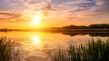 Scenic View Of Beautiful Sunset Or Sunrise Above The Pond Or Lake At Spring Or Early Summer Evening.