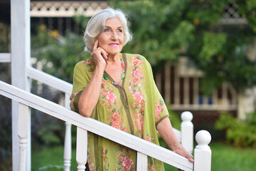 Poster - A beautiful elderly walks near their house 