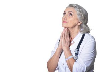 Wall Mural - senior female doctor posing against white background