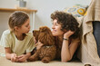 Mother and daughter lying together on the floor with their dog and enjoying leisure time