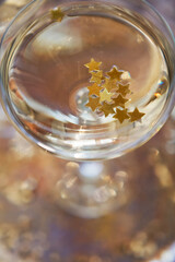 Wall Mural - Glass of champagne with golden stars