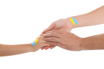 Wall Mural - Man and woman with painted Ukrainian flags on their hands against white background, closeup