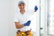 © Angelov - Master's work. Close-up of young handyman setting new windows at the appartment