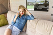 © Angelov - Shot of a beautiful woman using a smartphone while relaxing at home