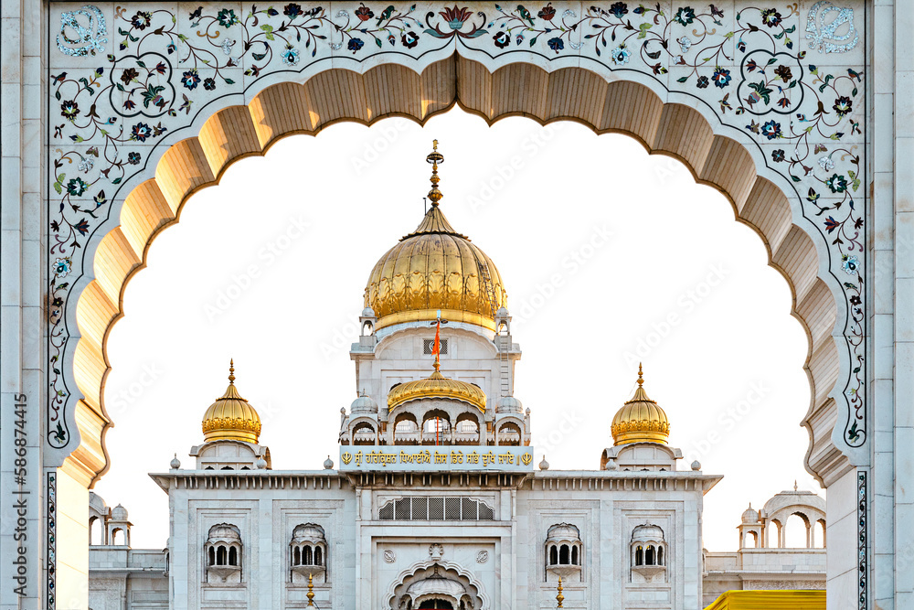 The golden temple of Gurudwara Bangla Sahib Sik is seen through the archway. Delhi. India.
