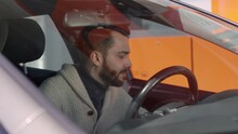 Slow Motion Footage Of Young Bearded Man Leaving Driver Seat And Taking Fuel Nozzle At Gas Pump