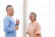© artitwpd - Romantic and cheerful Asian well-being senior couple enjoy dancing and holding hands to music together with smiles and happiness in the living room. Senior retirement activity at home.