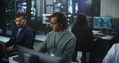 Poster - Young Team of South Asian Specialists Working on Computers and Having a Conversation at a Workplace. Two Male Software Developers Discussing a Solution for Their Artificial Intelligence Project