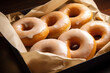 Glazed, plain donuts in a box