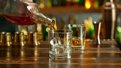 Wall Mural - Detail of whisky bottle, pouring shot into glass, super slow motion. Filmed on high speed cinema camera, 1000fps.