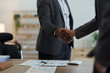 © Jirapong - african american and asian people hand shaking successful corporate partnership deal welcoming opportunity in office agreement professional greeting meeting colleagues partners