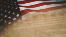 Fourth Of July With Flag And Bill Of Rights/ 4k Motion Graphics Of A Vintage Background Of Mixed Old Printed Declaration Of Independence Of The United States With Waving American Flag For Fourth Of Ju