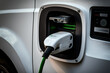 © ADDICTIVE STOCK - Electric car charging at charging station.