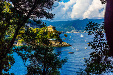 Fishing Boats Moored On Water In Harbor Of Ligurian And Mediterranean Sea Near Coastline Of Riviera Di Levante Of National Park Cinque Terre Coast With Blue Sky, Riomaggiore Village, Liguria, Italy.