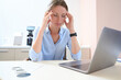 © Svitlana - Female is having headache during the work at the laptop in the room indoors