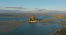 Fly Over Mont Saint-Michel, One Of Europe's Most Unforgettable Sights. Located In The Bay Where Normandy And Brittany Merge, The Island Attracts The Attention Of Tourists From All Over The World