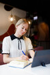 © 4otograf - Businesswoman Yulia works remotely in a cafe