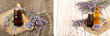 Herbal oil and lavender flowers on old wooden background