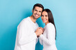 © deagreez - Profile photo of two positive cheerful partners hold arms toothy smile isolated on blue color background