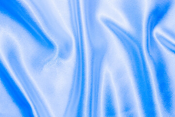 Wall Mural - Blue shiny texture of silk satin satin with folds.