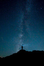 Silhouette Of A Man Standing Under Starry Night Sky
