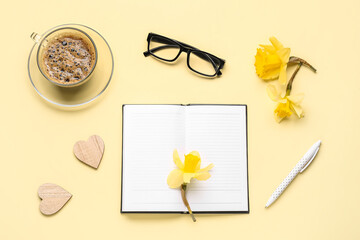 Wall Mural - Composition with blank notebook, coffee cup and flowers on yellow background