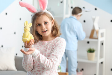 Poster - Little girl in bunny ears with Easter rabbit at home