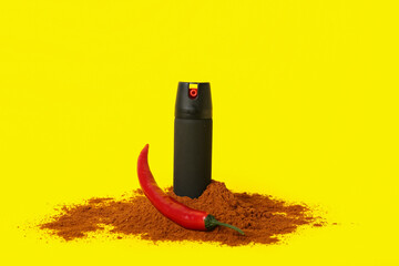 Spray with chili pepper and powder on yellow background