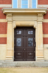 Poster - View of brick building with wooden door