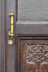 Wall Mural - View of old wooden door in city, closeup