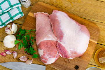 Wall Mural - Spanish Secreto de cerdo - raw pork cinch with parsley and peppers in plate. High quality photo