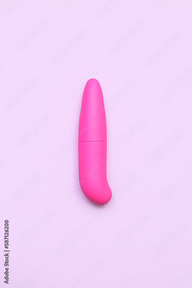 Pink vibrator from sex shop on lilac background