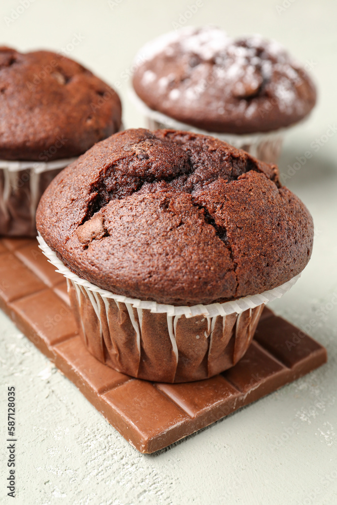 Tasty chocolate cupcakes on light background