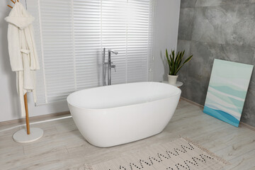 Wall Mural - Stylish bathroom interior with ceramic tub and houseplant