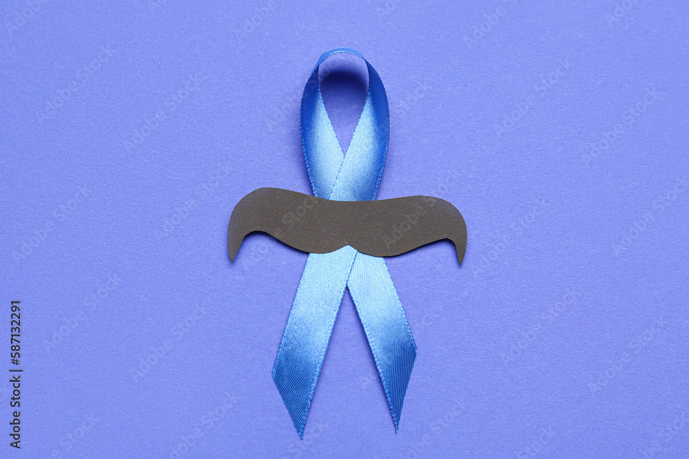 Awareness ribbon with paper mustache on blue background