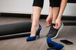 © artursfoto - Woman changing high heels to sport running shoes. Exercise after office, healthy living concept.